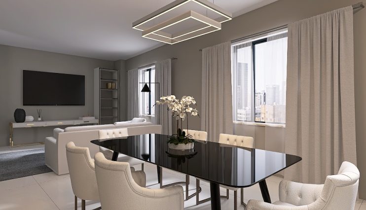 Moderna sala da pranzo e soggiorno con un elegante tavolo nero circondato da sedie bianche imbottite. Un centrotavola di orchidee bianche adorna il tavolo. La stanza presenta pareti neutre, ampie finestre con tende trasparenti e un lampadario contemporaneo.